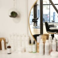 black and silver office rolling chair beside mirror